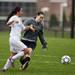 Huron senior keeper Ariel Freed makes contact with Dexter junior Bethany Shiguango on Tuesday, April 23. She was given a yellow card. Daniel Brenner I AnnArbor.com